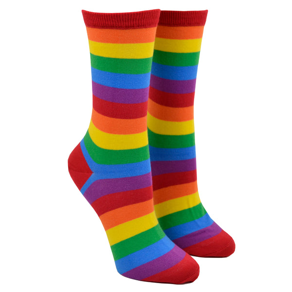 Shown on a leg form, a pair of Hot Sox cotton women’s crew socks with classic, bright, horizontal rainbow stripes