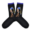 Shown in a flatlay, a pair of women's Hot Sox brand cotton crew socks in black with a blue cuff. These socks feature the iconic Johannes Vermeer painting 'The Girl with a Pearl Earring' and a 3D pearl detail.