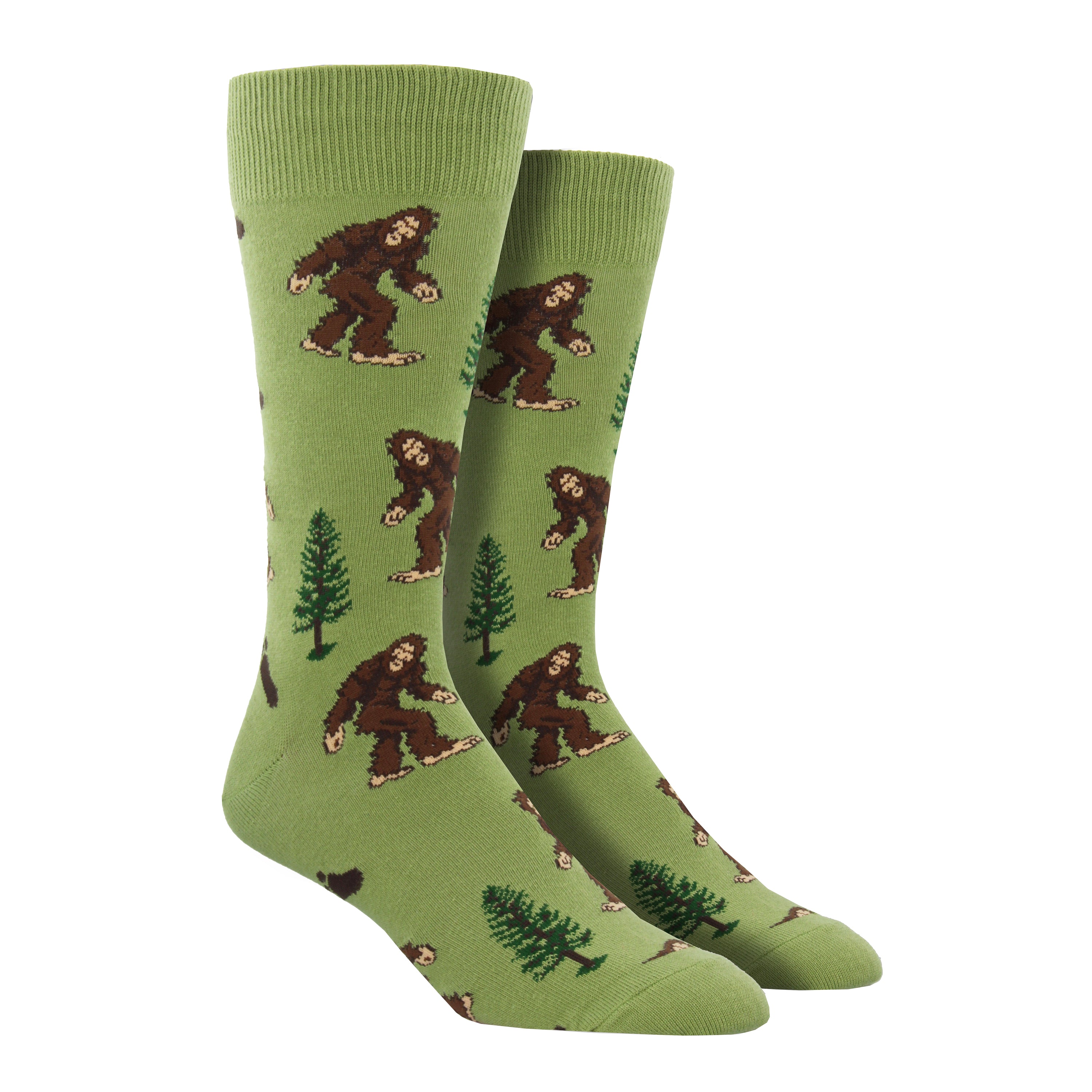 Shown on a leg form, a pair of Socksmith's light green cotton men’s crew socks with Bigfoot pattern