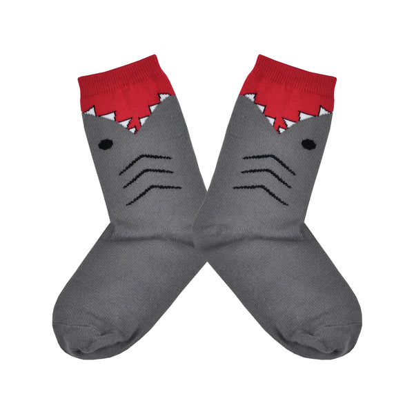 Shown in a flatlay, a pair of K.Bell brand grey cotton kids crew socks. The foot and heel of the sock are grey with the top being red with the design of shark teeth around it.