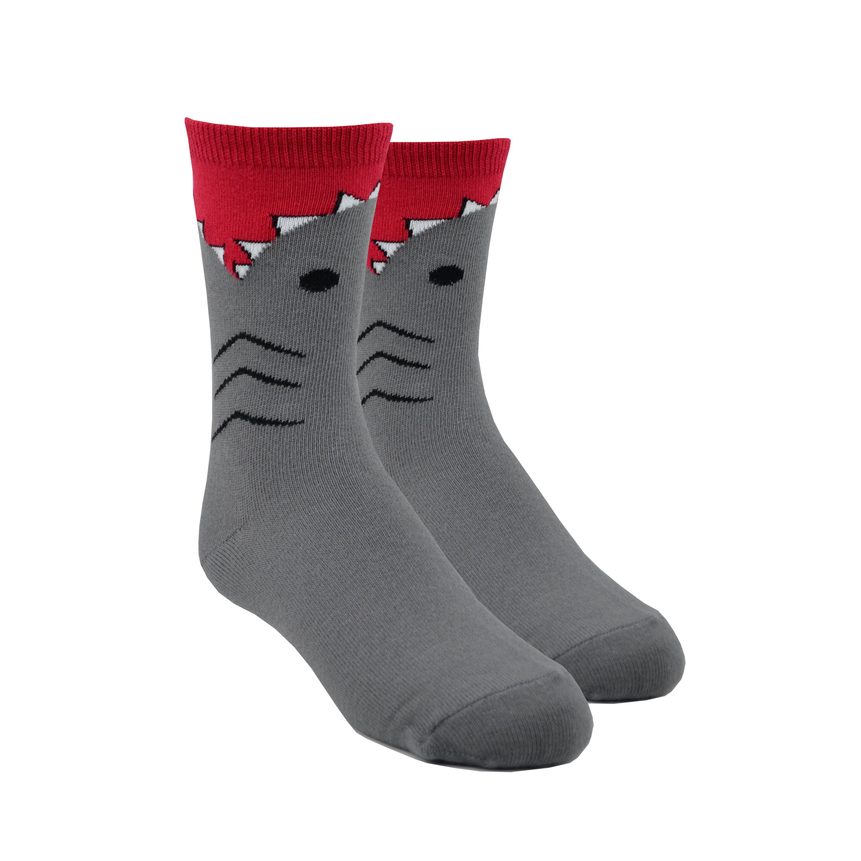 Shown on leg forms, a pair of K.Bell brand kids cotton crew socks in grey. The foot and heel are grey with the top being red with a shark teeth design around it.