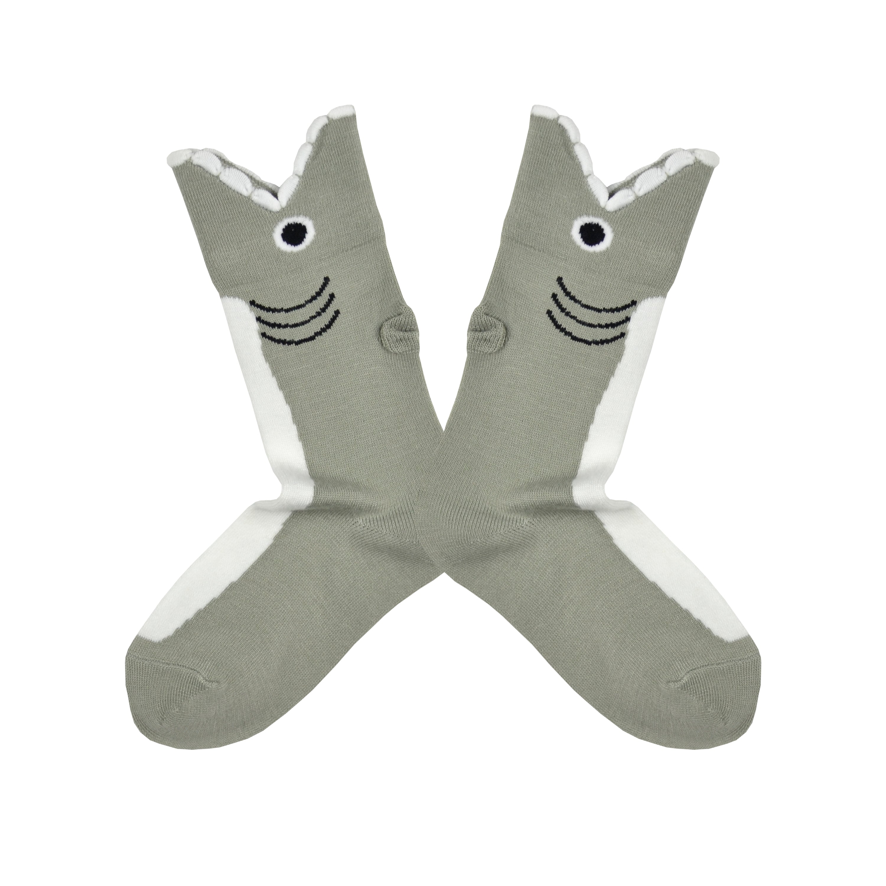 Shown in a flatlay, a pair of K.Bell brand kids crew socks in grey. The top of the sock features a fish mouth cuff on a grey sock with a white front.