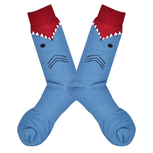These blue cotton men's novelty crew socks with a red top and cuff by the brand K Bell make it look like a shark is eating your leg, showing the sharks gills, eyes and teeth chomping on your calf.