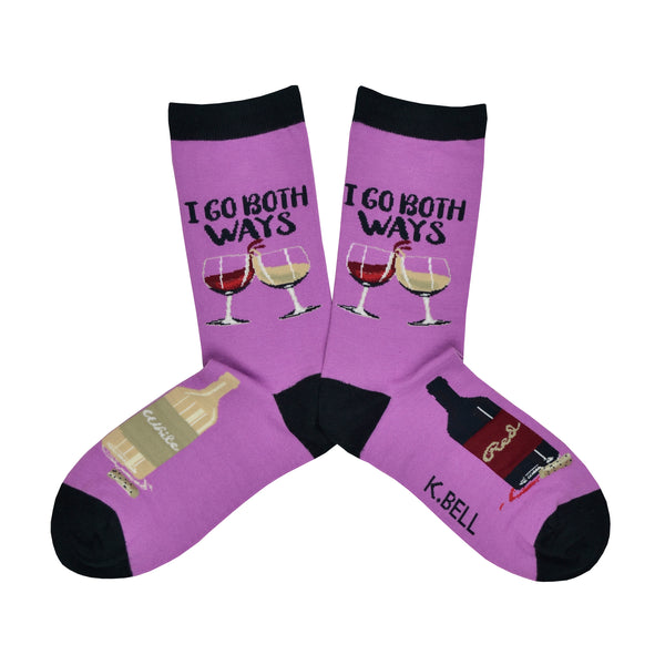 Cotton blend women's purple socks with a black heel, toe, and cuff shown in a flatlay. These socks feature calf design of two glasses of wine, one red and one white, with the words, "I Go Both Ways" above. The foot features alternating bottles of red and white wine.
