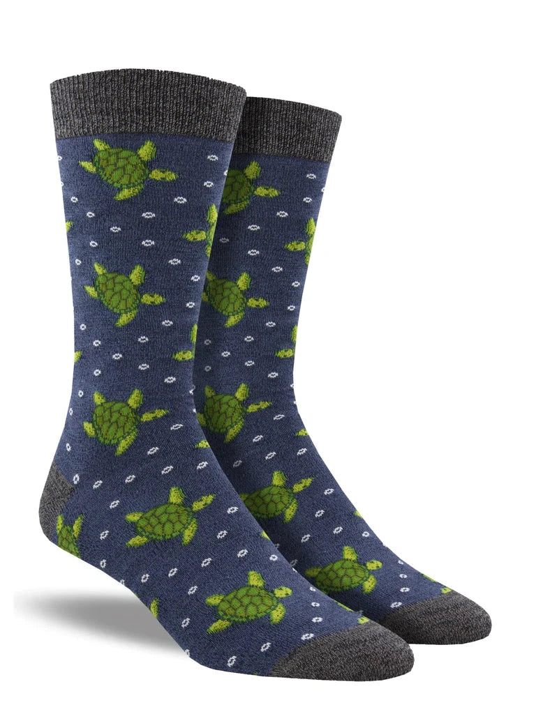 2 footforms wear blue socks with gray heel, toe and ankle featuring green sea turtles and small white bubbles