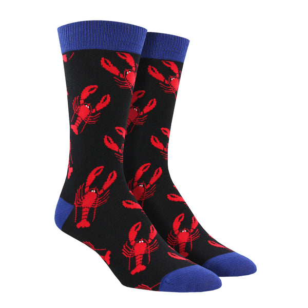 Shown on a leg form, a pair of Socksmith's bamboo men's crew socks in black with red lobster print