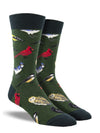 Shown on a leg form, a pair of Socksmith's dark green cotton men’s crew socks with wild North-American bird pattern