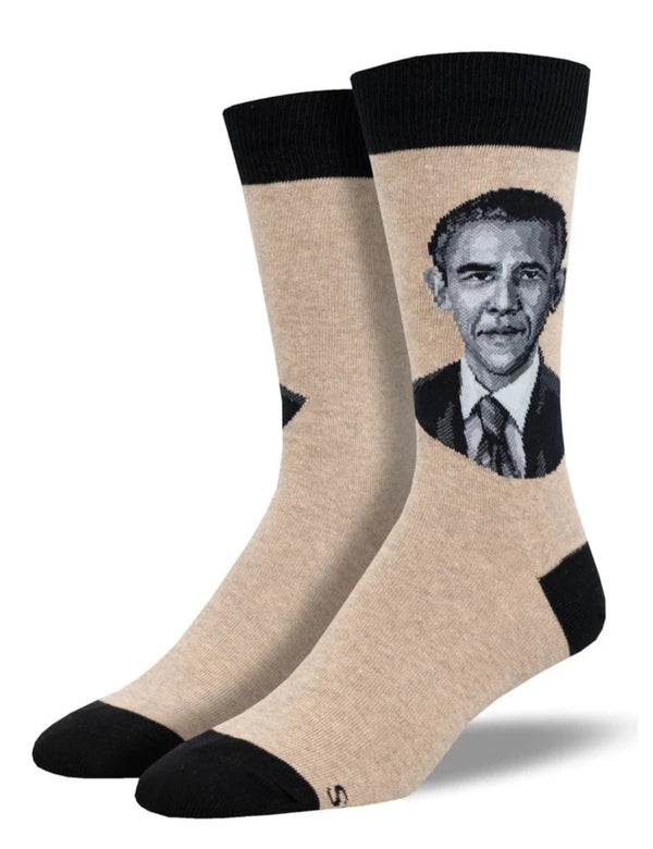 beige socks with black toe, heel and cuff seen on a leg form with barack obama's black and white presidential portrait on the sides of the legs