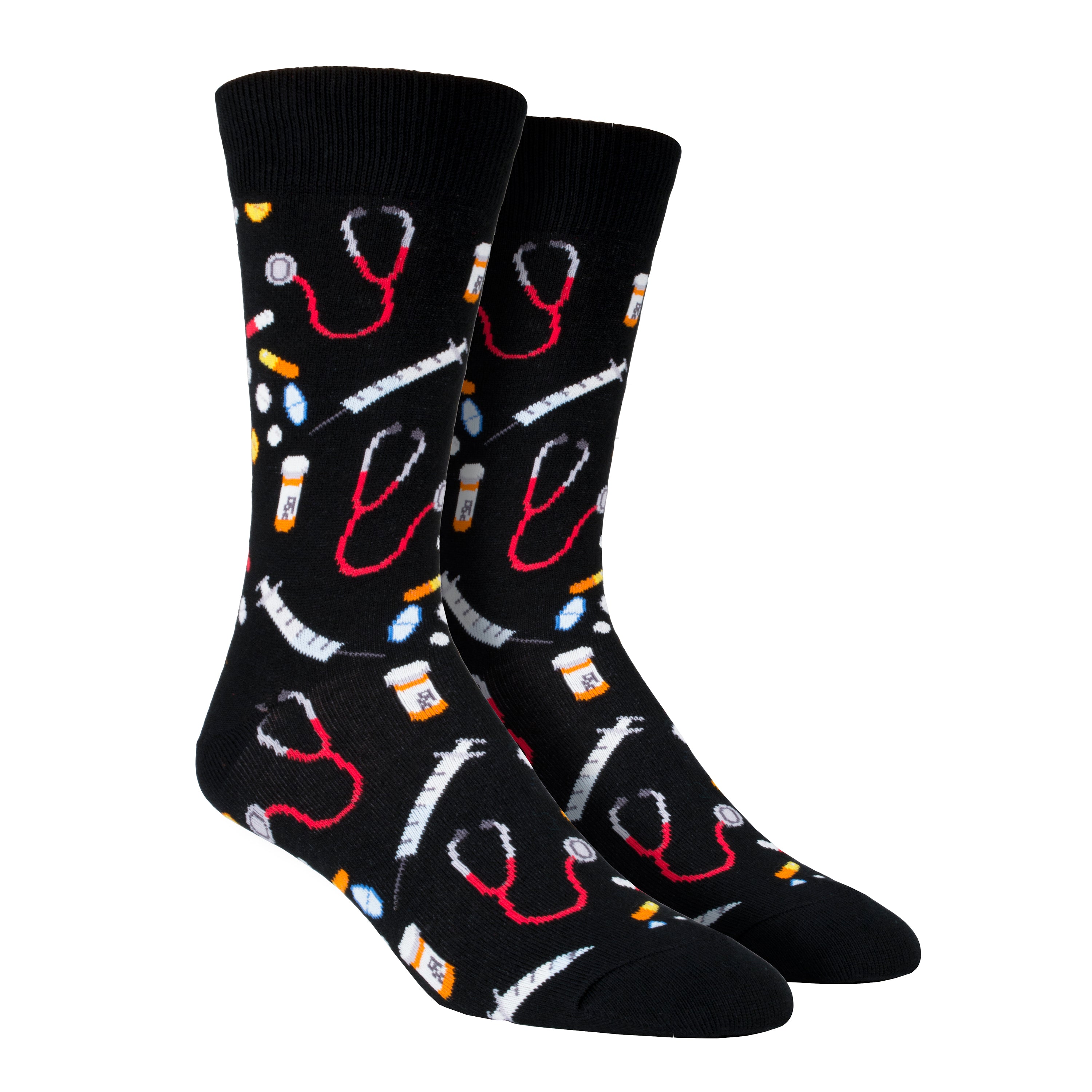 Shown on a leg form, these black cotton men's crew socks by the brand Socksmith feature multi colored medicines, pill bottles, stethoscopes, and needles, making them the perfect gift for a doctor or nurse.