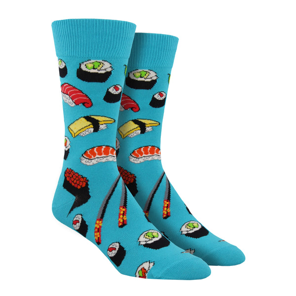 Shown on a foot form, a pair of Socksmith's sky blue cotton men's crew socks with various types of sushi rolls and chopsticks in an all-over pattern