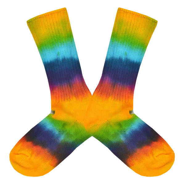 Shown in a flatlay, a pair of unisex Maggie’s Organic cotton crew socks with tie dye of yellow, green, blue, red and purple