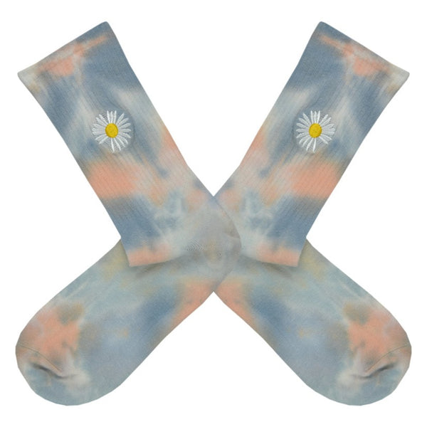 These blue and blush tie-dye cotton women's crew socks by the brand Me Moi have a small embroidered white daisy on the leg.