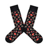 Shown in a flatlay, a pair of MeMoi's black bamboo men's crew socks with various small mushrooms in an all over pattern
