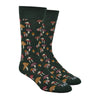 Shown on a foot form, a pair of MeMoi's dark green bamboo men's crew socks with various small mushrooms in an all over pattern