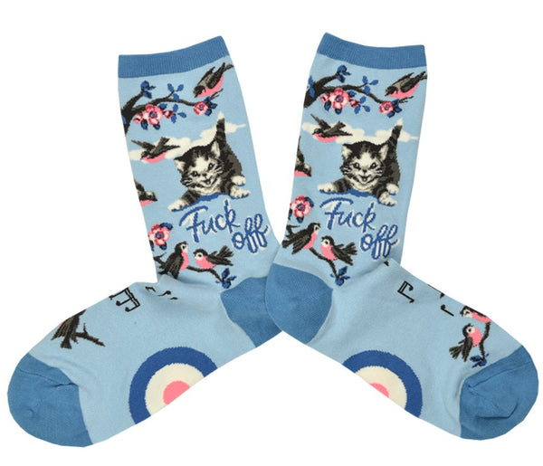 Shown in a flatlay, a pair of Mod Socks brand women's cotton crew socks in blue with a dark blue heel, toe, and cuff. The sock features a flowering branch with birds on the leg and foot and a meowing cat on the leg with the words "Fuck Off" in cursive.