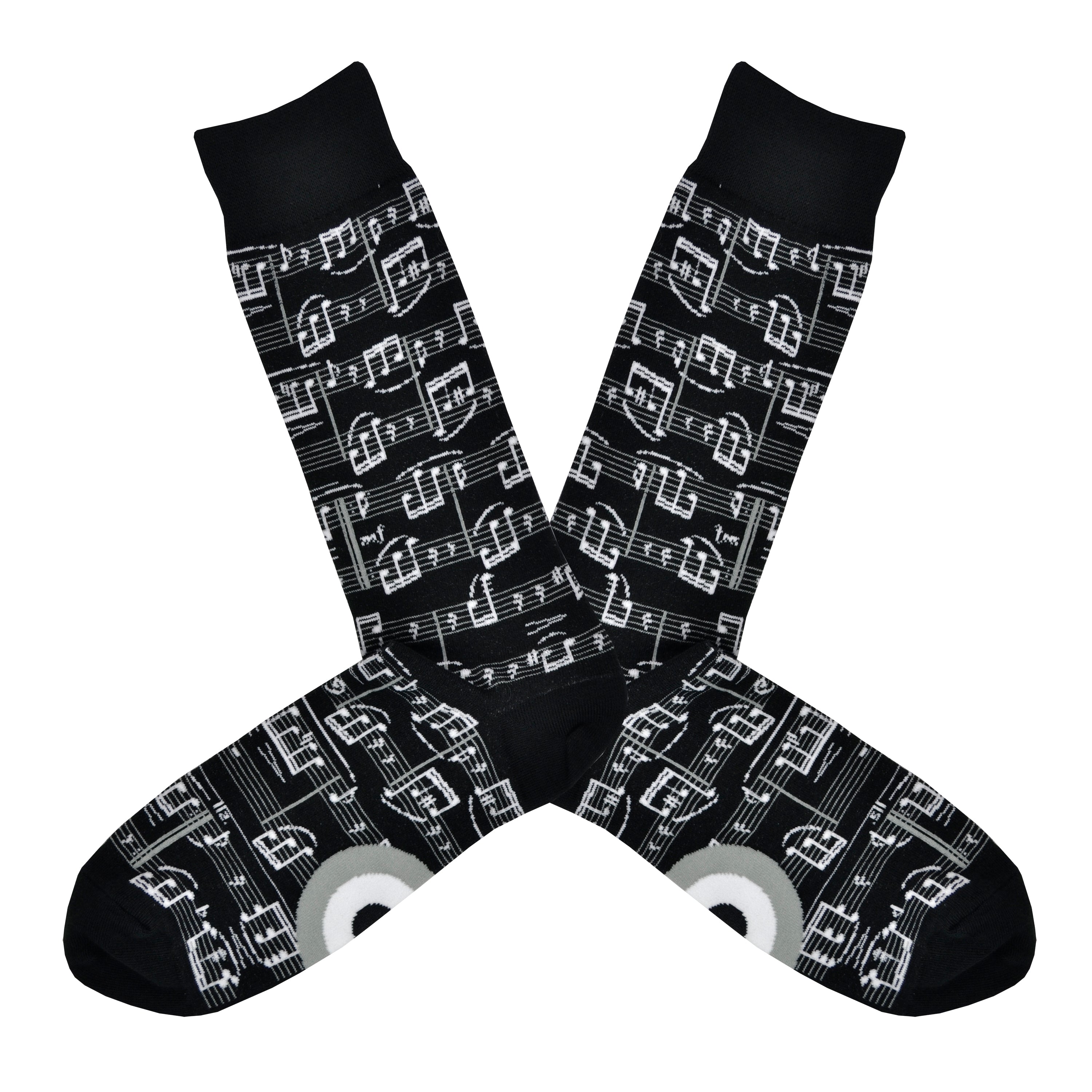 A black men's cotton crew sock by Modsock is shown on a flatlay featuring sheet music all along the sock from top to bottom. 