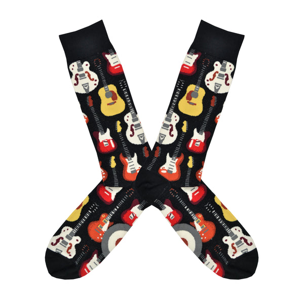 Shown in a flatlay, a pair of Mod Socks’ black cotton men's crew socks with various guitar instruments