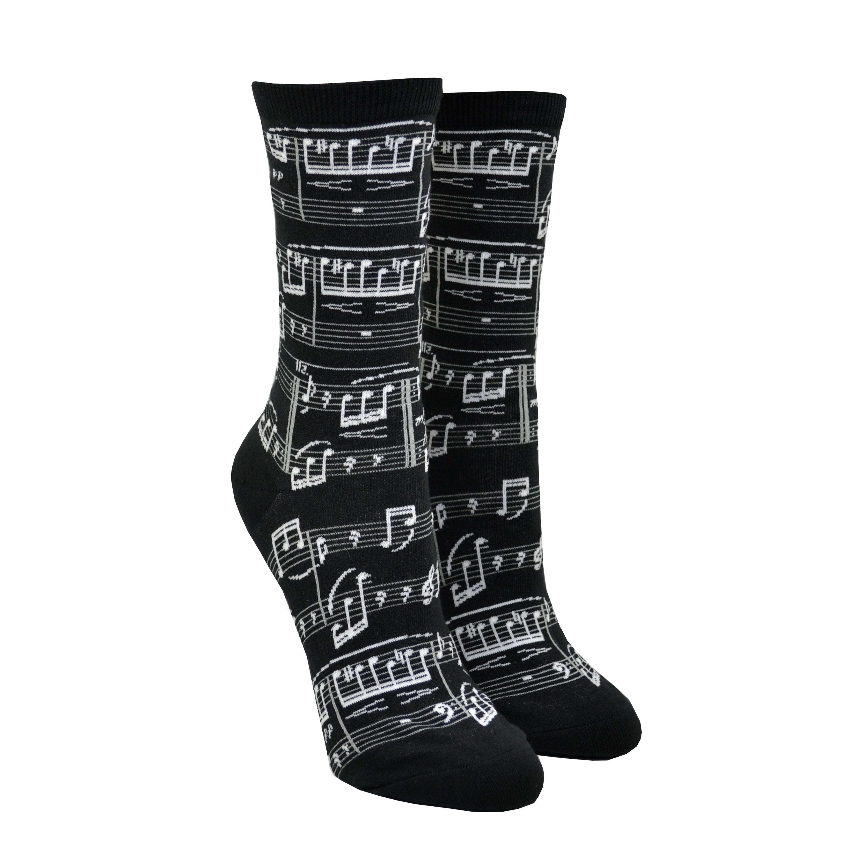 Shown on a foot form, a pair of Mod Socks’ black cotton women's crew socks with white print of small sheet music and musical notes
