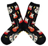 Shown in a flatlay, a pair of women's ModSocks cotton socks in black with an all over motif of red and white guitars going down the sock.