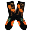 Shown in a flatlay, a pair of Mod Socks’ black cotton women's crew socks with cute brown bear hugging orange California map, surrounded by orange poppies