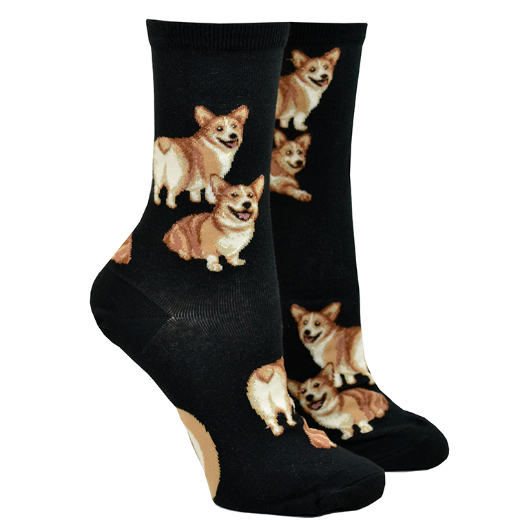 Shown on leg forms, a pair of Mod Socks brand women's cotton crew socks in black. The sock features an all over motif of blonde  corgi dogs with their little heart shaped butts facing out.
