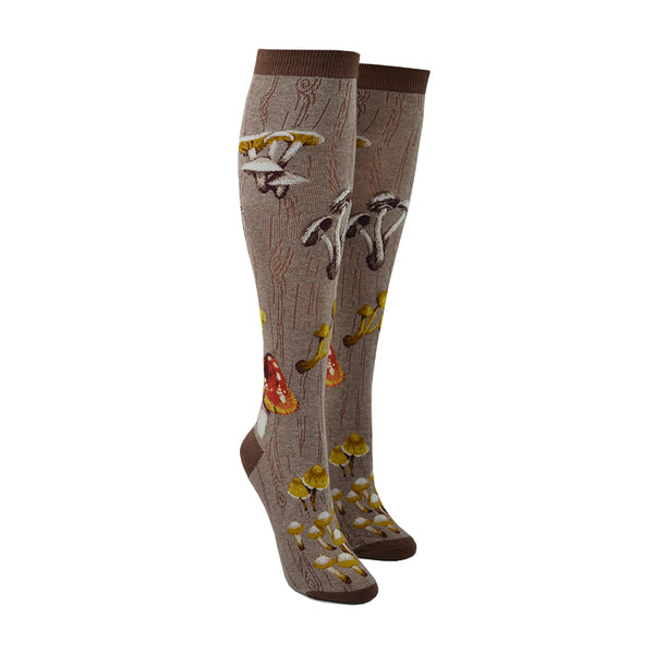 Shown on a leg form, these heather brown cotton women's knee high socks feature a variety of red, brown and yellow mushrooms throughout.