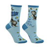 Shown on a leg form, these blue cotton women's crew socks feature an adorable puppy sweetly smiling with dainty yellow flowers and butterflies throughout and the text "Not Your Bitch" written on the leg.