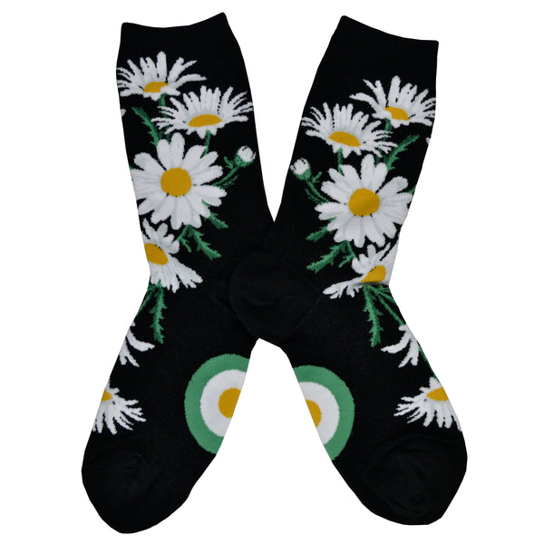 Shown in a flatlay, a pair of ModSocks brand women's cotton crew sock in black with an all over design of classic white and yellow daisies.