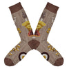 Shown in a flatlay, a pair of Mod Socks’ brown cotton men's crew socks with a large design of different kinds of mushrooms