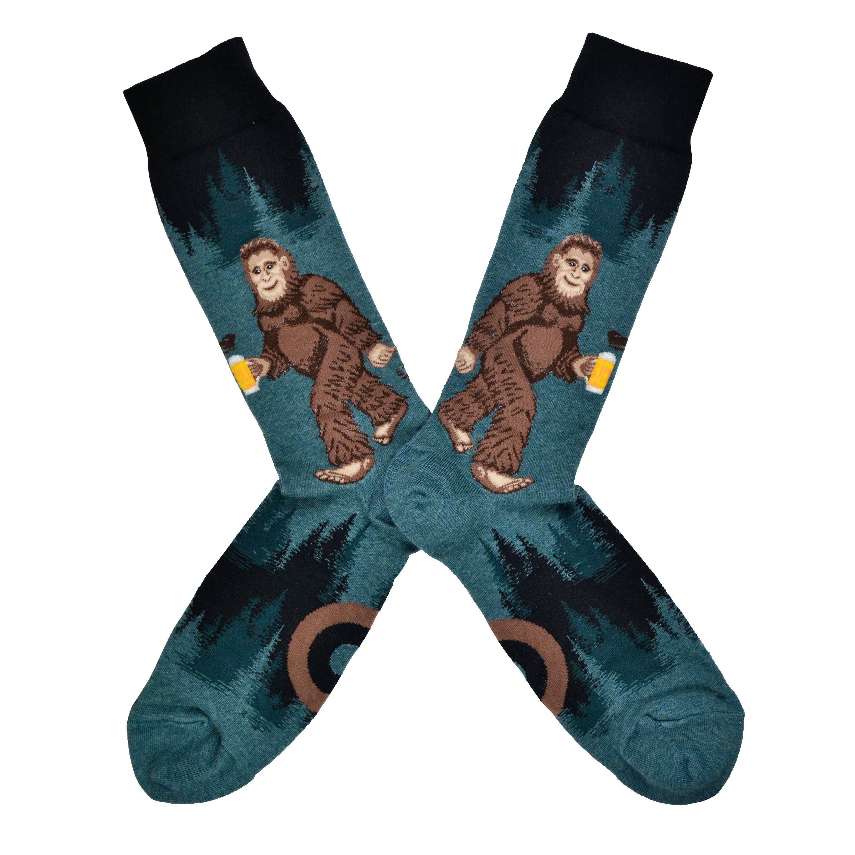 These heathered blue/green and black funny men's cotton crew socks by Mod Socks feature Big Foot walking amongst the trees drinking a beer.