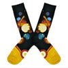 Shown in a flatlay, a pair of Mod Socks’ black cotton men's crew socks with the entire planetary system in large detail