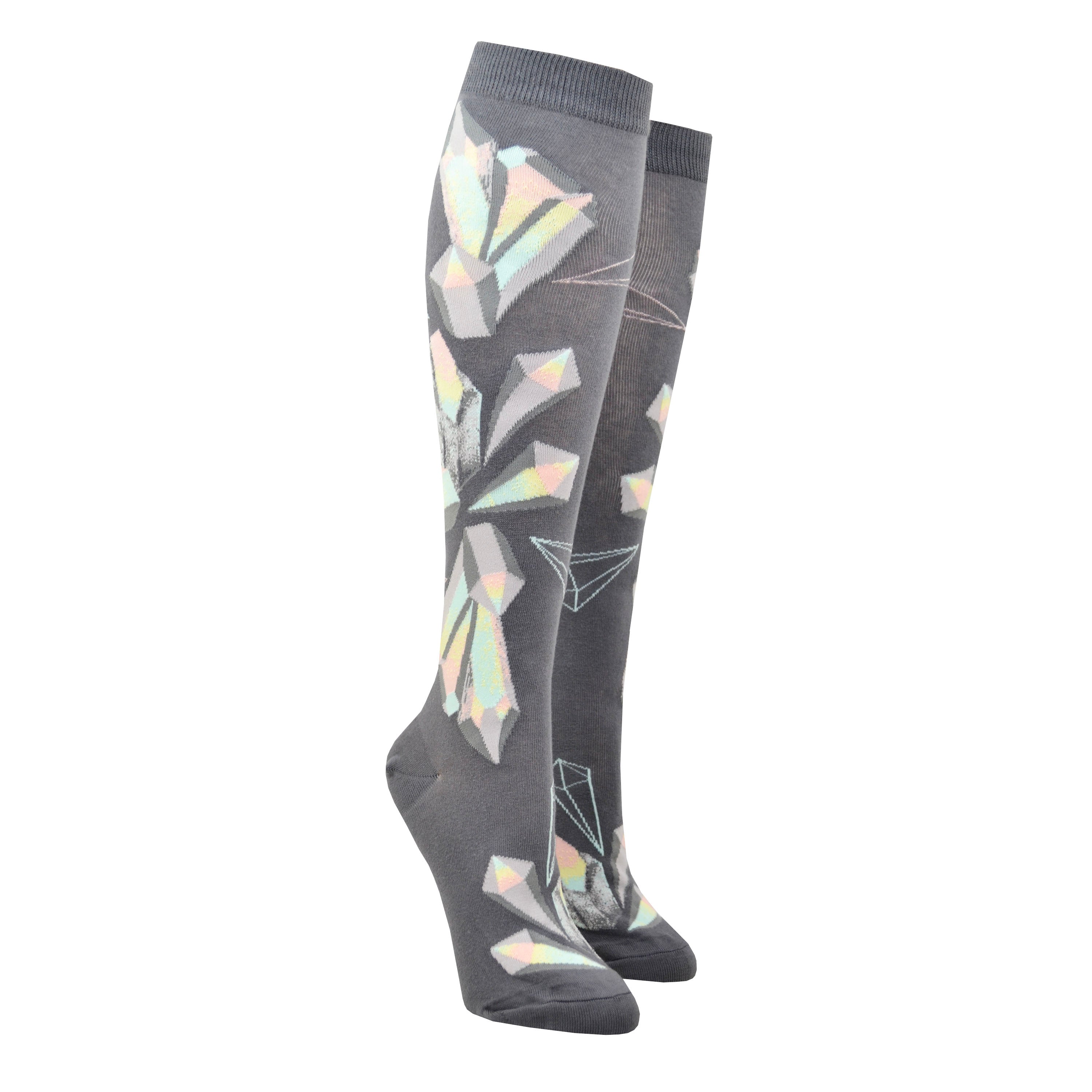 Shown on leg forms, a pair of ModSocks brand women's cotton knee highs. These grey socks feature an all over design of pastel blue, green, pink, and yellow crystals.