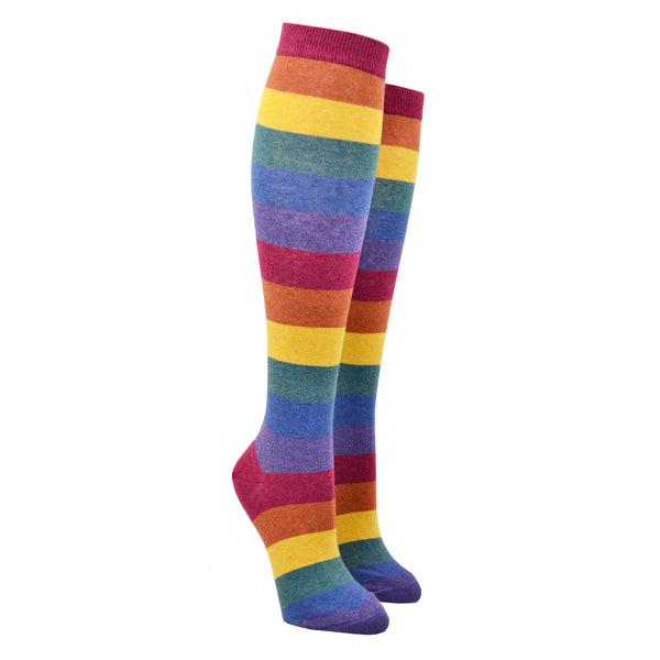 Shown on leg forms, a pair of women's knee high cotton socks by ModSocks. These socks feature a muted rainbow stripe in red, burnt orange, matte gold, emerald green, dark blue, and purple.