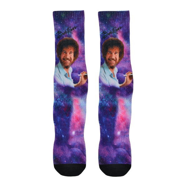 Famous artist Bob Ross is shown painting while floating through a galaxy background of this purple unisex cotton crew sock by Good Luck socks.