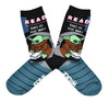 These blue and black cotton unisex crew socks by the brand Out of Print feature the Star Wars Mandalorian character Baby Yoda reading, with the text "Read This Is The Way" written on the top of the leg.