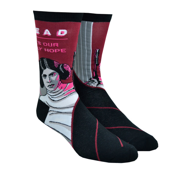 Shown on leg forms, a pair of Out of Print brand unisex cotton crew socks. The heel, cuff, and toe are all black with the leg of the sock featuring Princess Leia from Star Wars and the text, " READ IT'S OUR ONLY HOPE".