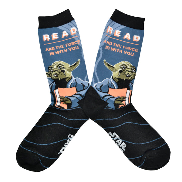 Shown in a flatlay, a pair of unisex Out of Print blue cotton crew socks with black cuff/heel/toe, white “READ: And The Force Is With You” text, and old Yoda holding book portrait