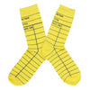 These yellow cotton unisex crew socks by the brand Out of Print feature the iconic library card design with the words "Author, Title, Date Due" written on the leg and a grid for filling in the information running down the leg and foot.