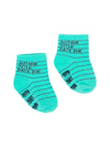 These kid's cotton crew socks in green by the brand Out of Print feature the iconic library card design with the words "Author, Title, Date Due" written on the leg and a grid for filling in the information running down the leg and foot.