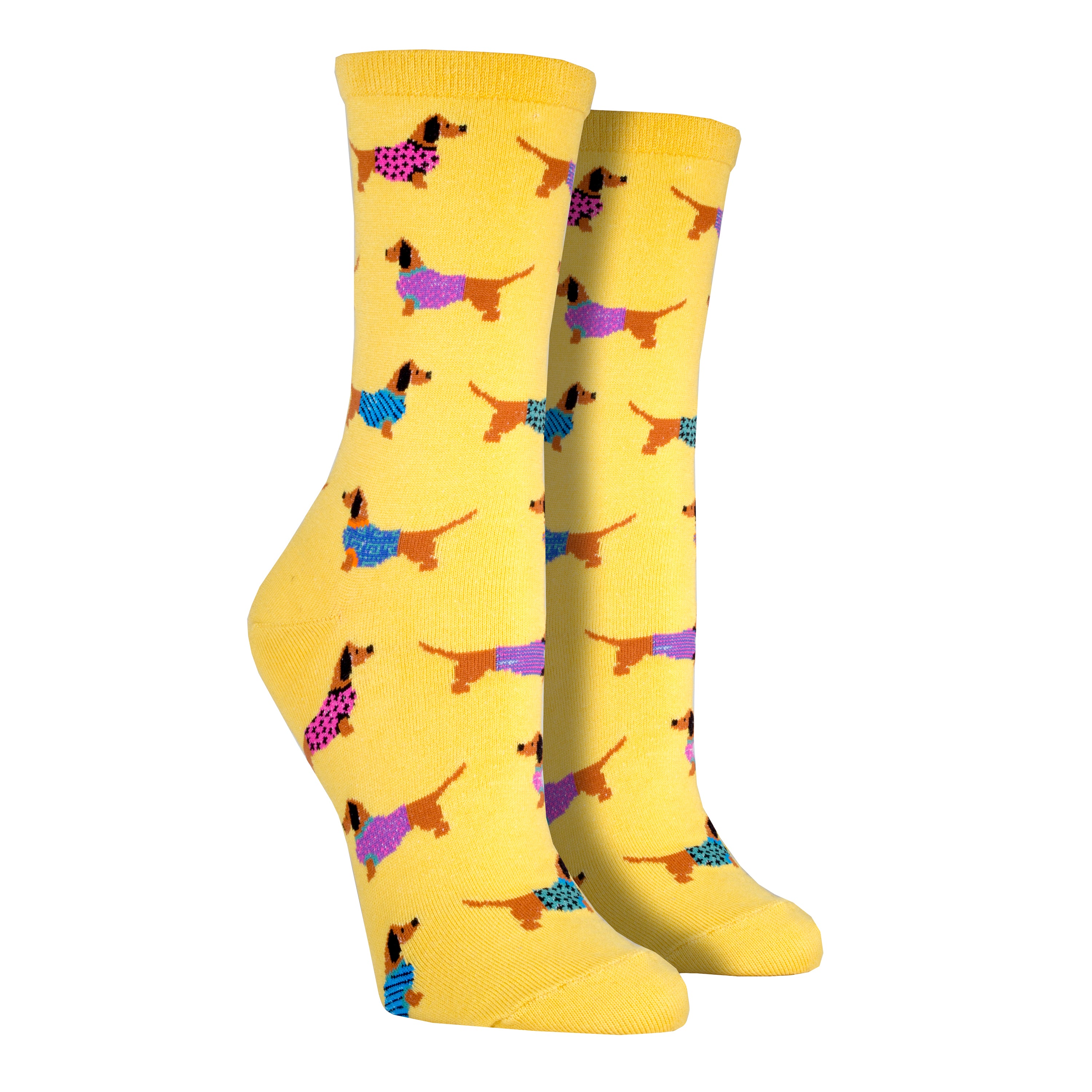 Shown on foot forms, a pair of women's SockSmith brand cotton crew socks in yellow with an all over motif of dachshund dogs in colorful sweaters.