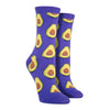 Shown on a leg form, these purple cotton women's novelty crew socks by the brand Socksmith feature light green avocados sliced in half showing their brown pits.