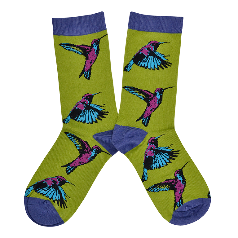 Shown in a flatlay, a pair of Socksmith brand women's bamboo crew socks in citron green with a purple toe, heel, and cuff. This sock features a pink and blue hummingbird design all over the sock.