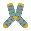 Shown in a flatlay, a pair of Socksmith brand women's bamboo crew socks in light blue with a yellow toe, heel, and cuff. This sock has an all over motif of little rainbows.