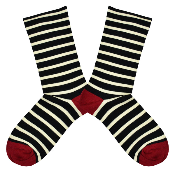 Shown in a flatlay, a pair of Socksmith brand women's bamboo crew roll-top socks in black and white stripes with a red heel and toe.