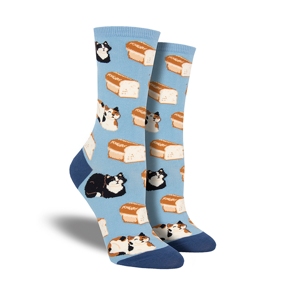 Shown on a leg form, a pair of Socksmith’s gray cotton women’s crew socks with various cats sitting like loaves and morphing into bread