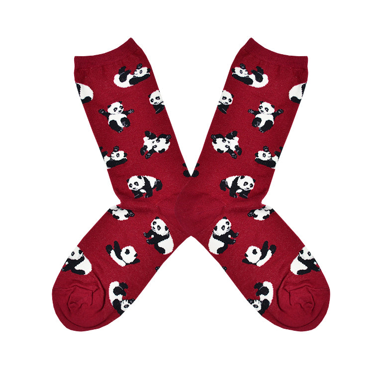 Shown in a flatlay, a pair of women's Socksmith cotton crew socks in red with an all over motif of little pandas rolling around.