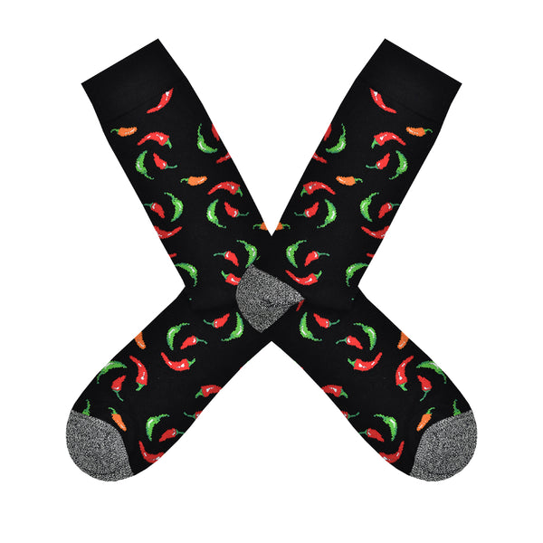 Shown in a flatlay, a pair of Socksmith's bamboo men's crew socks in black with red, yellow and green hot chili peppers