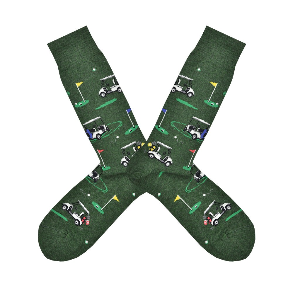 Shown in a flatlay, a pair of Socksmith's dark green cotton men's crew socks with golf hole markers and golf carts in an all-over pattern
