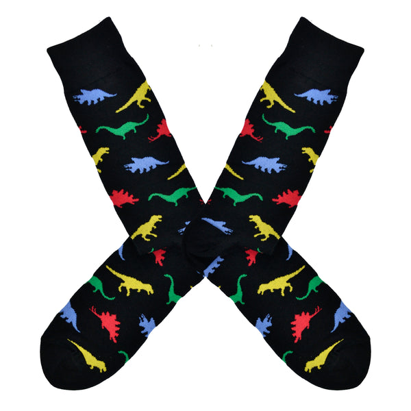 Shown in a flatlay, a pair of Socksmith's black cotton men's crew socks with multicolor dinosaur shape pattern
