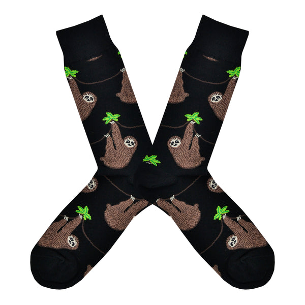 Shown in a flatlay, a pair of Socksmith's black cotton men's crew socks with chill sloths hanging from vibes
